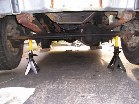 1978 Ford F-250 - The front axle and differential of a 1978 Ford F-250 are visible while it is supported by jack stands.