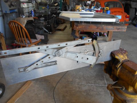 1992 Ford Bronco - Window regulator mechanism being worked on in a garage setting.