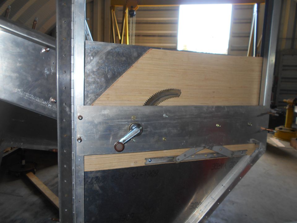 Metal jig with a circular saw blade and crank handle, likely for cutting metal