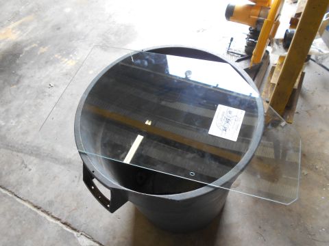 1992 Ford Bronco - A glass part rests on a drum, with a label visible on the glass.