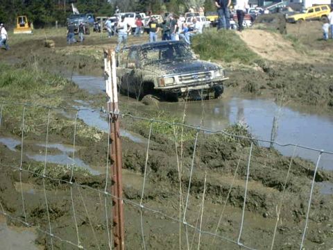 1995 Ford Bronco - Off-road event with a vehicle stuck in the mud and water.