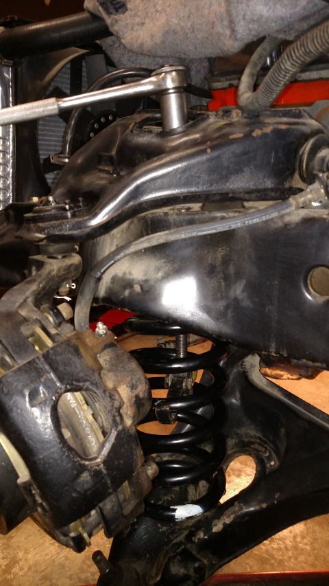 1979 Chevrolet Camaro - Close-up of a vehicle's front suspension system, with a socket wrench being used on a bolt. The Supermotors logo is visible at the bottom.