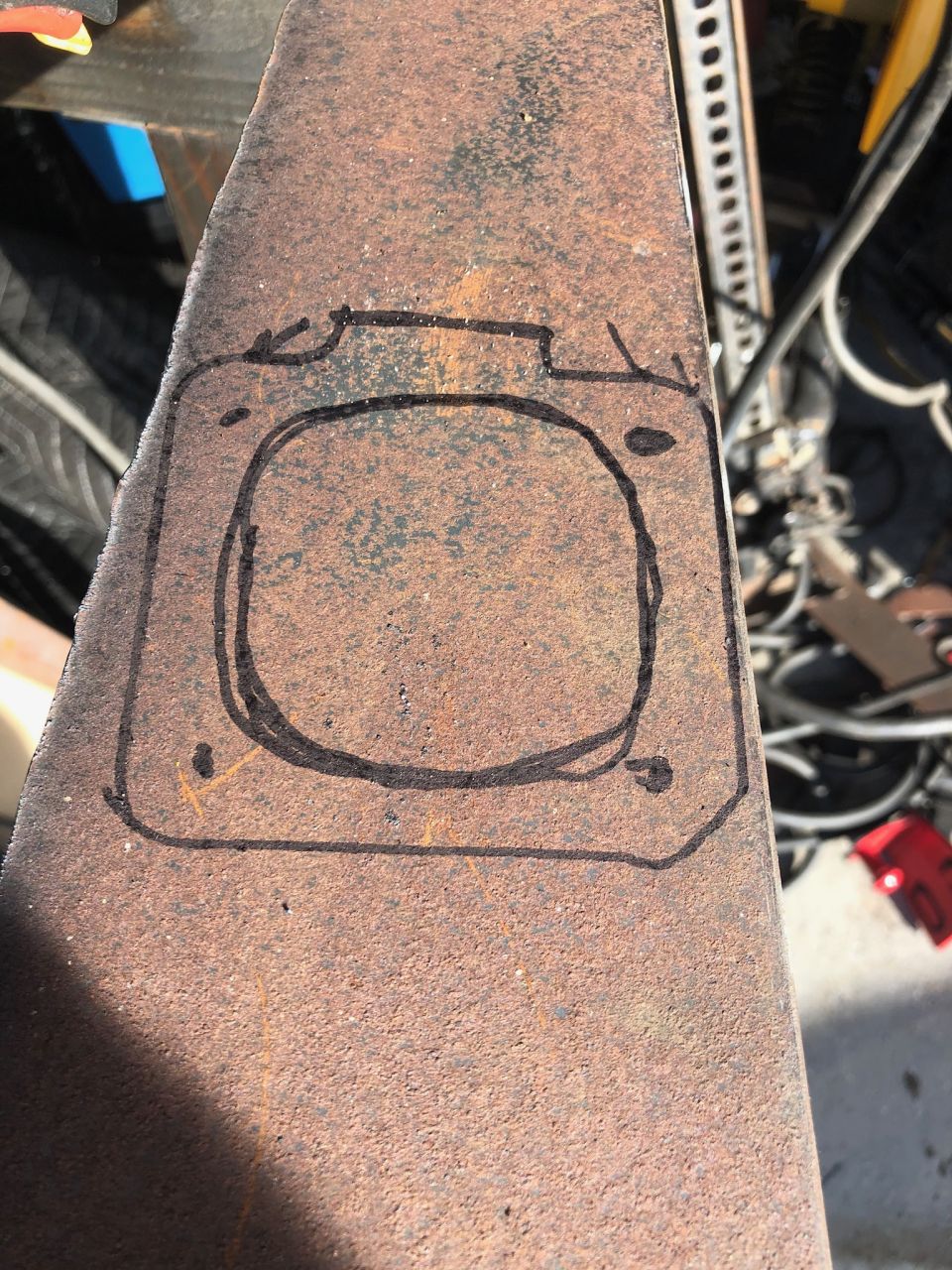 Gasket template drawn on rusty metal with Supermotors.net logo