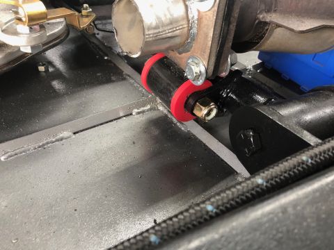 1992 Jeep Wrangler - Close-up of vehicle undercarriage parts, including bushings and exhaust system components.