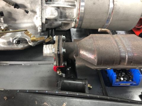 1992 Jeep Wrangler - Close-up view of a vehicle's exhaust system, including the catalytic converter and transmission linkage.