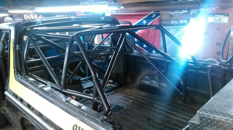 1978 Ford Bronco - A custom roll cage is installed inside a vehicle, obscuring most of the interior details.