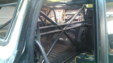 1978 Ford Bronco - The interior of a vehicle is visible, focusing on a complex roll cage structure.