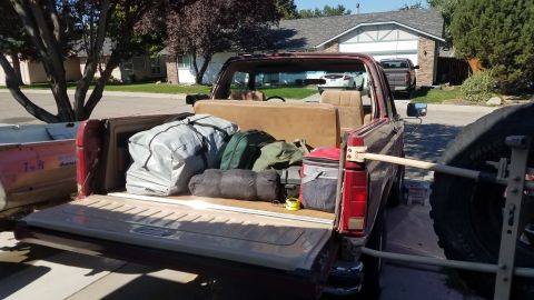 1985 Ford Bronco - This Ford Bronco, likely from the early 1980s, is packed with camping equipment for an outdoor adventure.