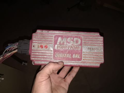 1994 Ford Bronco - A red MSD Ignition Digital 6AL ignition box is held by a hand, showing its part number and wiring.