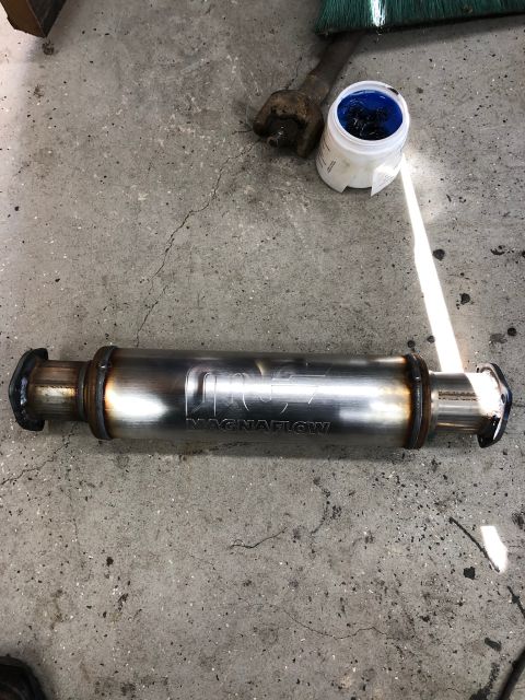 1992 Jeep Wrangler - A Magnaflow exhaust muffler is shown lying on a concrete surface, with its branding clearly visible.