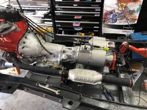 1992 Jeep Wrangler - Close-up of a Jeep transmission and exhaust system components, likely during a repair or build.