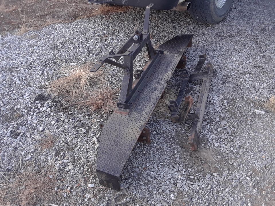 metal bumper assembly with diamond plate and frame parts on gravel