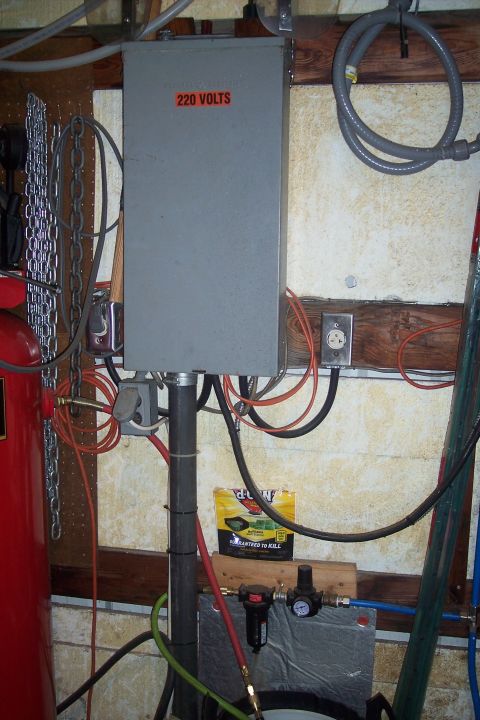 1995 Ford Bronco - A workshop scene showing electrical and air supply equipment, including a prominent 220 volt panel.