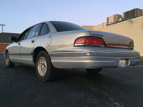 1994 Ford Crown Victoria - Rear view of a silver 1994 Ford Crown Victoria sedan parked outdoors.
