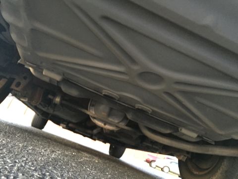 1994 Ford Crown Victoria - Underside view of a car, revealing the exhaust system and rear differential.
