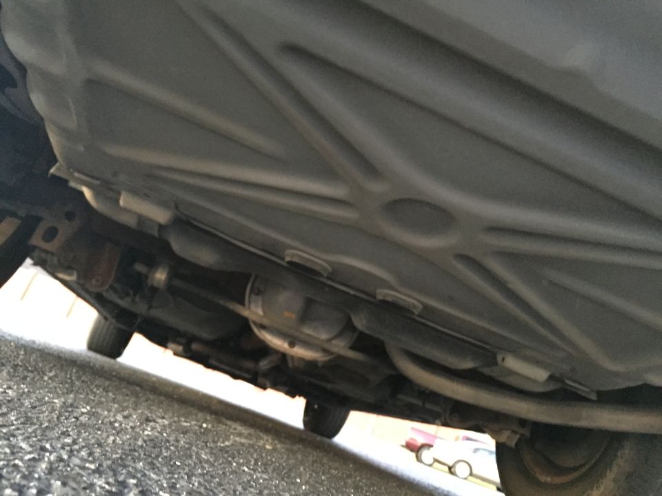 Underside view of a car showing the exhaust system and differential