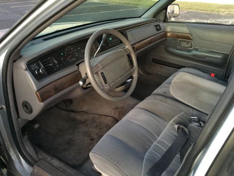1994 Ford Crown Victoria - Interior view of a 1994 Ford Crown Victoria, highlighting the dashboard and seating.