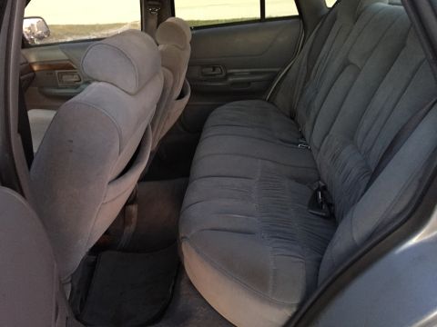 1994 Ford Crown Victoria - Rear interior view of a 1994 Ford Crown Victoria, showing the cloth seats and door panel.