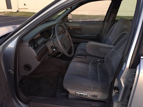 1994 Ford Crown Victoria - Interior view of a 1994 Ford Crown Victoria, highlighting the front seating area and dashboard.