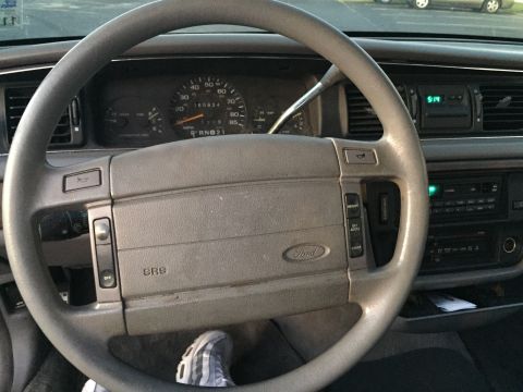 1994 Ford Crown Victoria - The dashboard of a 1994 Ford Crown Victoria, the steering wheel and instrument cluster.