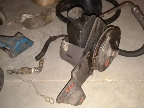 1994 Ford Bronco - Power steering pump assembly with pulley and hoses, possibly for an older Ford vehicle.
