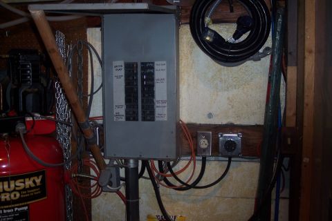 1995 Ford Bronco - Workshop scene showing an electrical panel and a red Husky Pro air compressor with various cords and chains.