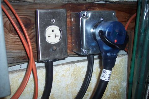 1995 Ford Bronco - Two electrical outlets are visible, one with a blue plug inserted that shows a red indicator light.