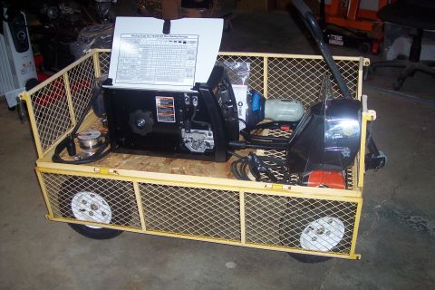 1995 Ford Bronco - A trailer filled with welding equipment is shown in a garage setting.