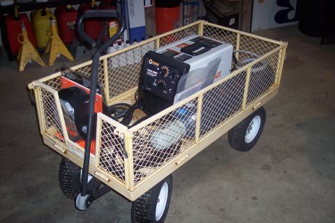 1995 Ford Bronco - A utility cart carries a welder and other items, likely in a workshop or garage setting.