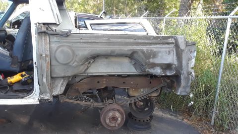 1994 Ford Bronco - This image shows the rear quarter panel of a pickup truck, revealing its exposed frame and suspension components.