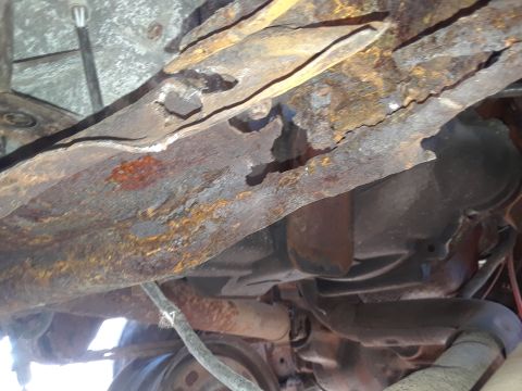 1994 Ford Bronco - Close-up view of severely corroded undercarriage components, showing significant rust damage.