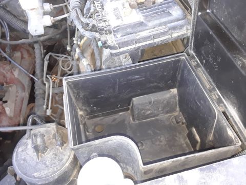 1994 Ford Bronco - Engine bay view shows an empty battery compartment and surrounding mechanical parts.