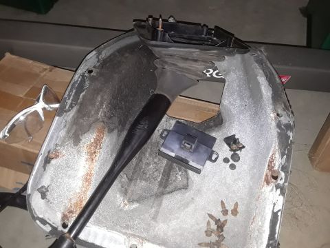 1994 Ford Bronco - A disassembled car part sits on a surface, showing signs of rust and wear.