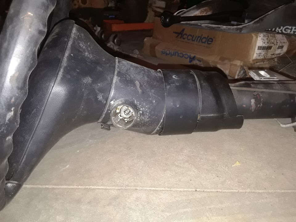 Black steering column with ignition cylinder visible