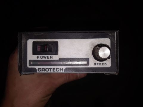 1994 Ford Bronco - A Grotech speed controller unit is held in a hand against a black background.