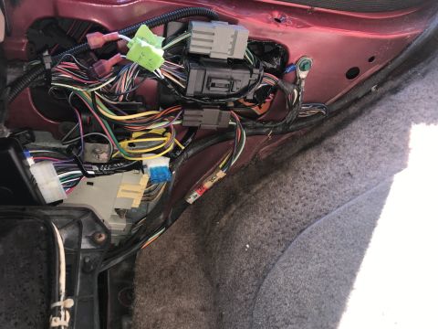 1994 Ford Bronco - Close-up of a complex vehicle wiring harness, showing numerous wires and electrical connectors.
