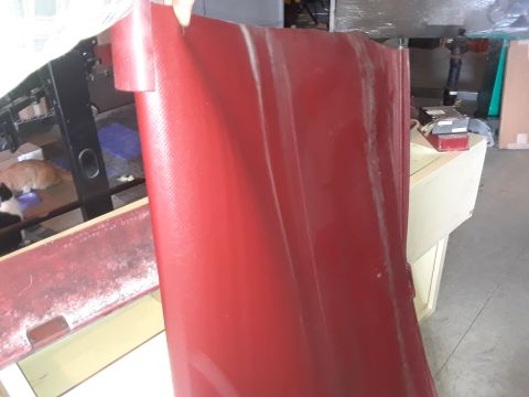 1994 Ford Bronco - A person holds a large, red, textured panel in front of a workbench with cats visible.
