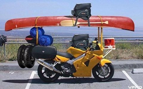 1992 Ford Bronco - This motorcycle is equipped for an extended outdoor adventure, carrying a canoe, sleeping bags, and extra tires.