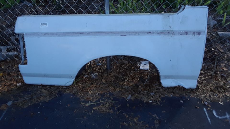 Light blue Ford Bronco rear quarter panel with a horizontal stripe