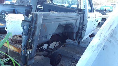 1994 Ford Bronco - This vehicle is in a state of disrepair, with significant parts removed and visible damage.
