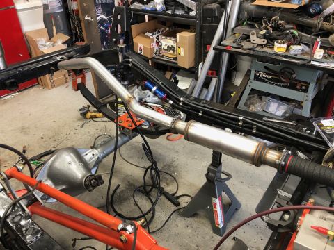 1992 Jeep Wrangler - A vehicle's exhaust system and rear axle are disassembled in a workshop setting.