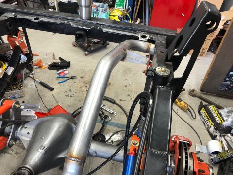 1992 Jeep Wrangler - Custom exhaust pipe installation on a vehicle frame, showing suspension and frame components.