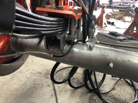 1992 Jeep Wrangler - Close-up of a vehicle's rear axle assembly, showing leaf springs and brake lines.
