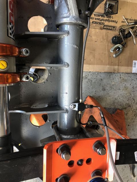 1992 Jeep Wrangler - Detail of a vehicle's suspension system, showing a brake line connected to a component.