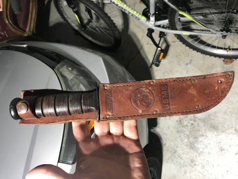2008 Ford Focus - A leather sheath for a combat knife is shown, USMC markings and an emblem.
