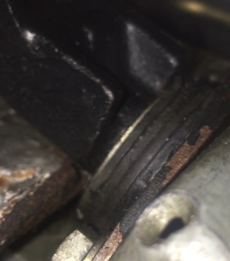 close-up of engine part showing rust and wear
