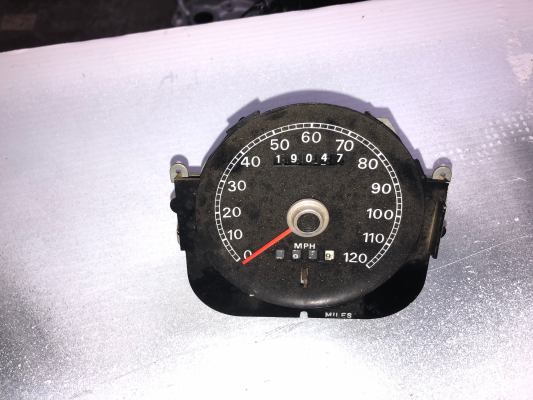Vintage car speedometer showing 19047 miles.