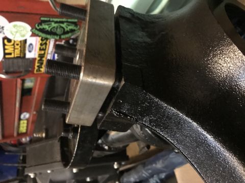 1989 Ford Bronco - A close-up view shows a black painted metal part of a vehicle, possibly a differential housing, with several threaded studs protruding from…