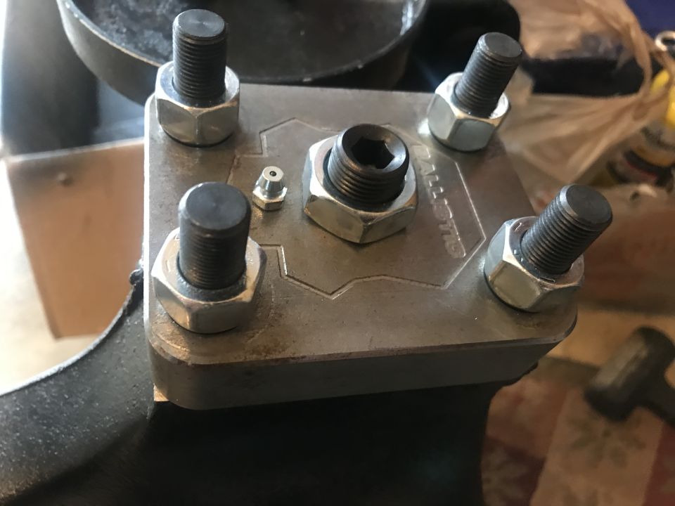 Metal bracket with bolts, nuts, hex bolt, and grease fitting, engraved with "BALLISTIC"
