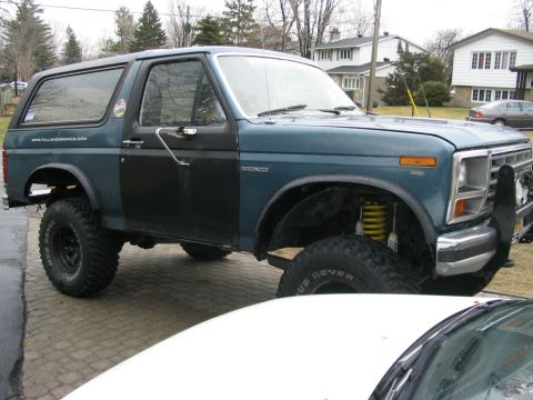 1986 Ford Bronco - This Ford Bronco has a lifted suspension with yellow shocks visible.